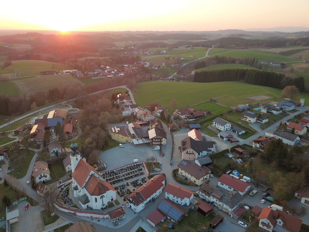 Luftaufnahme der Dorfmitte von Otterskirchen mit Kirche St. Michael im Abendlicht